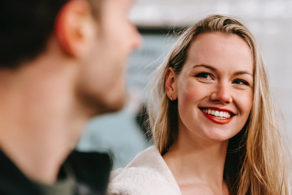 Woman smiling at a man